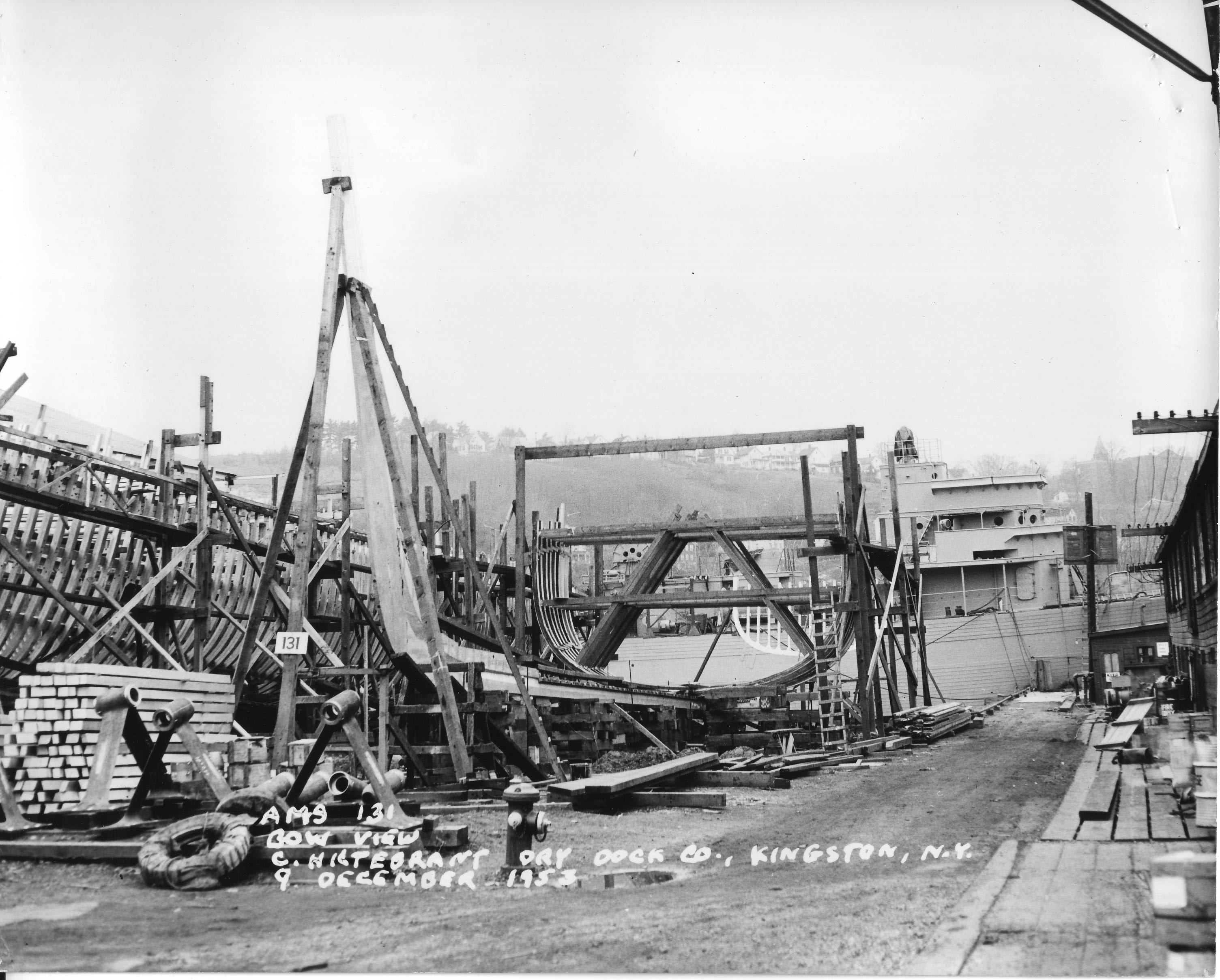 The minesweeper “AMS 131” is being built at C. Hiltebrant Dry Dock Company, Kingston, 9 December 1953. Wooden boat building along the Rondout Creek in the 1950s experienced an unexpected boom. The United States Navy used wooden minesweepers to deactivate magnetic mines throughout the Korean War. Today, wooden boat building is taught to high school students in the Hudson River Maritime Museum’s YouthBoat program. HRMM Collection